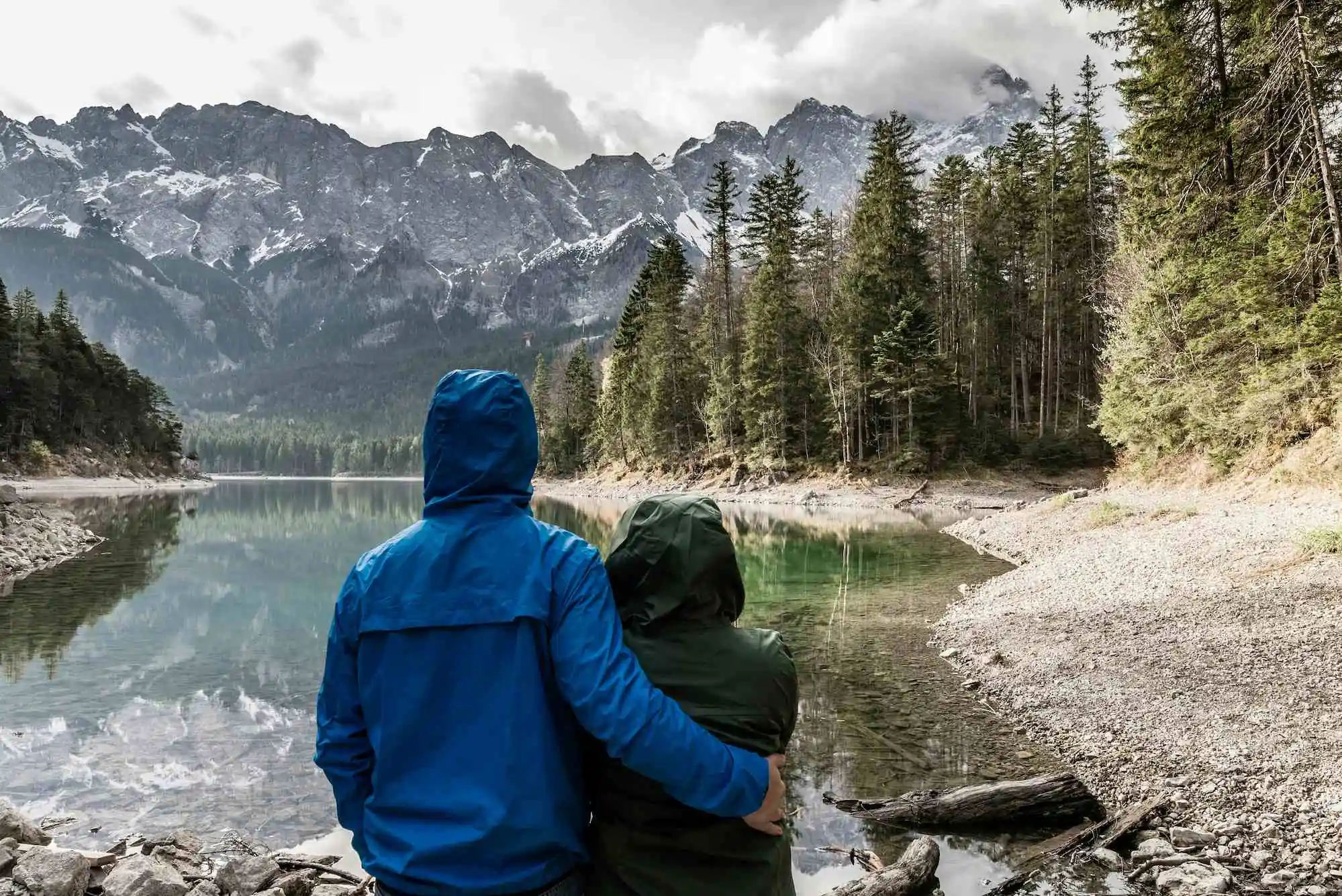 two people watching the lake and mountains